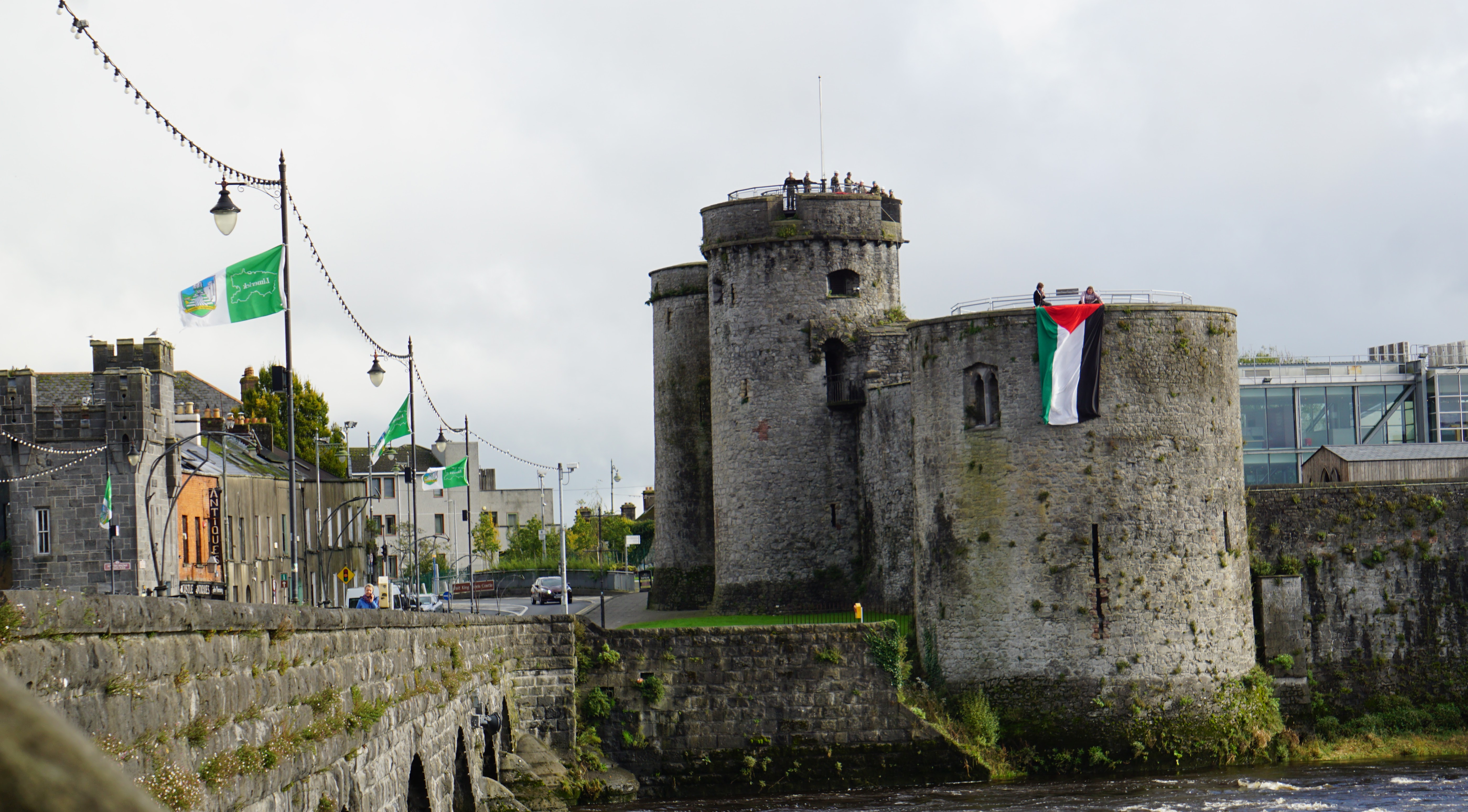 Activists hang a giant Palestine flag from the ramparts of King John's Castle in Limerick